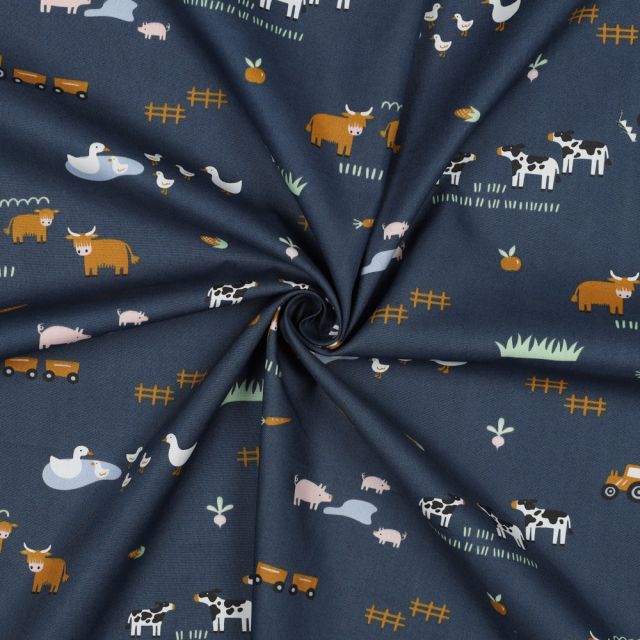 Cows, ducks pigs and tractors on blue cotton fabric. Farm scene print